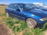 a blue car that is parked in the grass