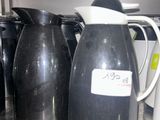 a lot of coffee pots and cups on the counter
