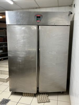 two stainless steel refrigerators in a kitchen next to each other