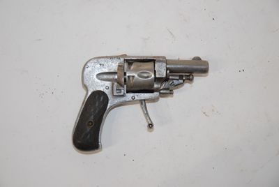 a small gun that is on a white surface