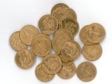 a pile of gold coins sitting on a white surface