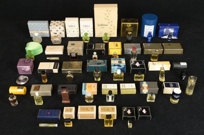 many different types of perfumes on a black surface