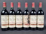 six bottles of red wine are lined up in a row