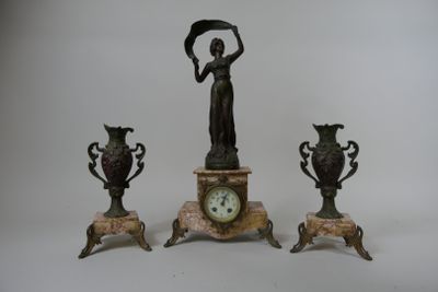 three bronze statues of a woman holding a fan and a clock