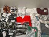 several pairs of shoes and clothes are on a shelf in a closet