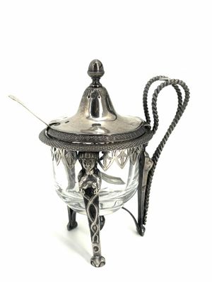 an antique silver teapot with a handle on a white background
