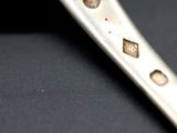 a close up of a knife on a black surface