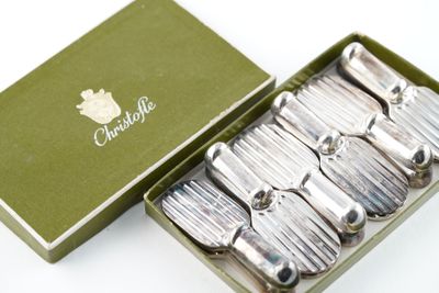 a box of silver spoons in it on a table