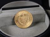 une pièce d'or posée dans un écrin sur une table