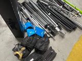a pile of skis and ski poles on the ground