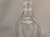 a clear glass bottle with a stopper on top of it