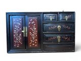 a black cabinet with a floral design on it