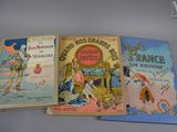 three children ' s books are lined up on a table
