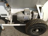 a white trailer with a pump attached to the side of it