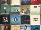 many different album covers on the wall of a room