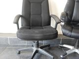 two office chairs sitting next to each other on a tiled floor