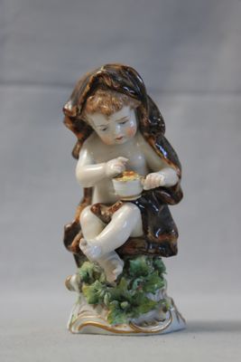 a figurine of a child sitting on a tree stump