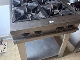 a stove that is sitting in the middle of a kitchen