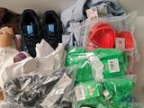 many bags of clothing and shoes on a shelf
