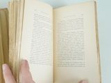 a person that is holding a book in their hand