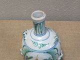 a small blue and white vase sitting on a table