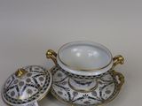 two porcelain bowls and a saucer on a white surface