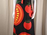 a mannequin wearing a dress with tomatoes and tomatoes on it