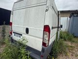 the back end of a van that is parked in a field