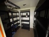 a small room with a shelf and shelves in it