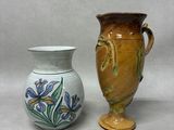 two vases sitting next to each other on a table