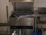 a kitchen with a stove, sink, and other items in it