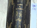 a black book with gold designs on it sitting on a table