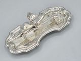 an antique silver plate with a horse and carriage on it
