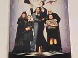 a poster of the addams family on the wall