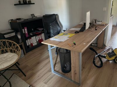 un bureau sur lequel se trouve un ordinateur, dans un salon