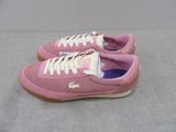 pink tennis shoes with white laces are on a gray surface