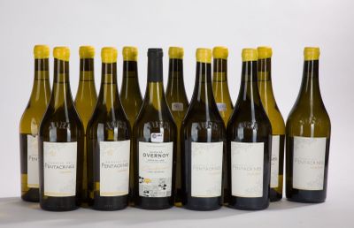 six bottles of wine are lined up in a row on a table