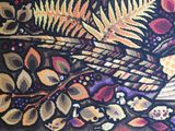 a close up of a rug with a pattern of leaves and flowers