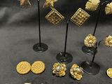a collection of gold and silver earrings and brooches
