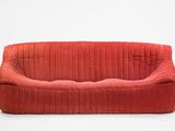 an image of a red couch sitting on top of a white floor