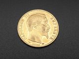three different types of gold coins on a black surface