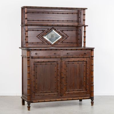 an old wooden cabinet with a mirror on top of it