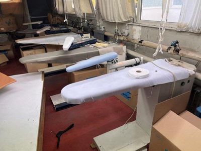 many ironing boards in a room with a lot of boxes