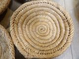 four wicker baskets sitting on the floor next to each other