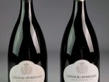 two bottles of wine sitting next to each other on top of a table