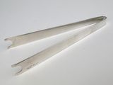 pair of stainless steel tonges on a white surface