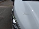 a close up of a car ' s hood with a hole in the hood
