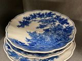 three blue and white plates stacked on top of each other