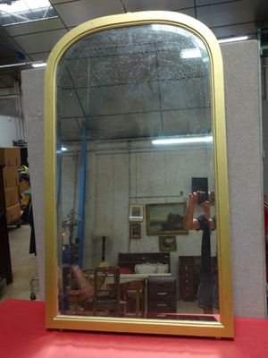a mirror that is sitting on a table in a room