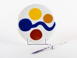 a white plate with a blue, yellow, and red design on it